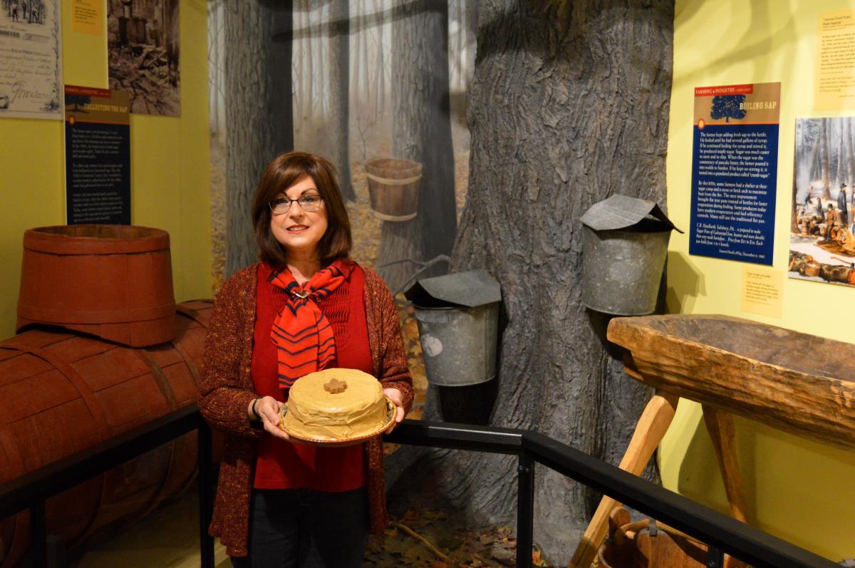 Woman holding a burnt sugar cake