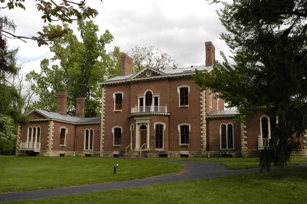 Ashland, The Henry Clay Estate is a red brick mansion with large white stone on the corners of the house and white detailing around the windows.