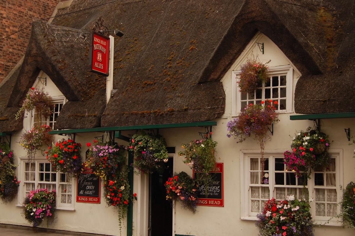 picture of a house in Horncastle covered with flower baskets