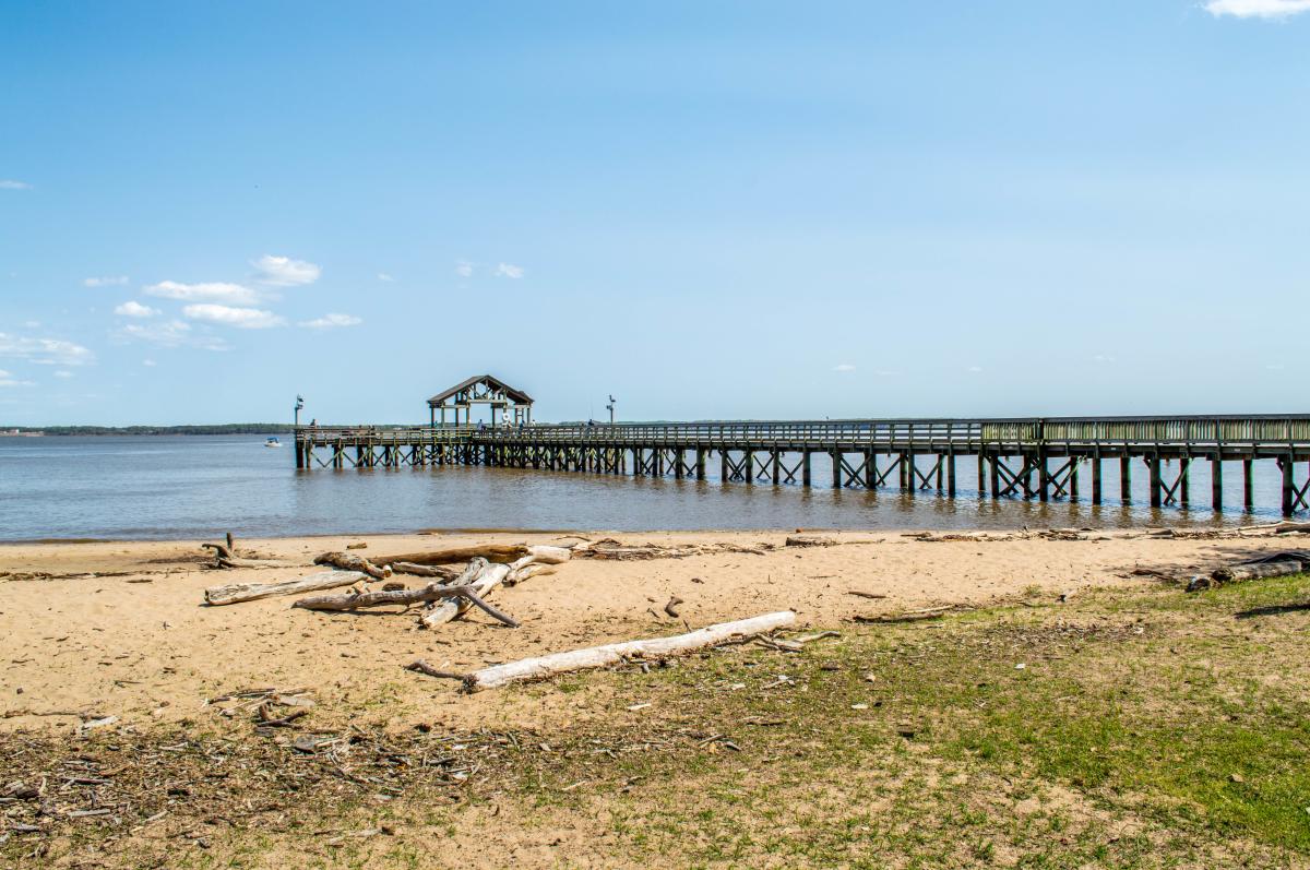 view of the fishing pier and water from the sandy beaches of Leesylvania State Park