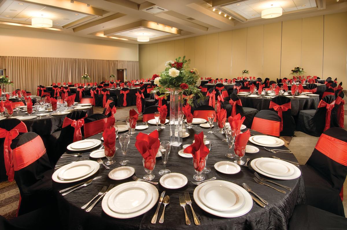 Tables are set up for a reception in a banquet room inside the Drury Plaza Hotel Broadview