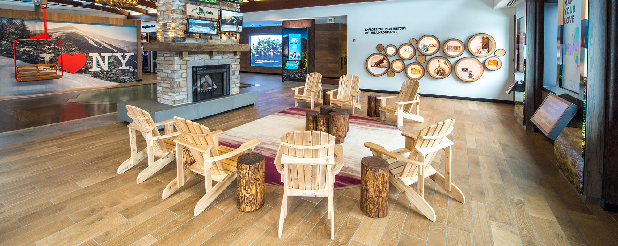 Adirondack chairs and a fireplace on display at the Adirondack Welcome Center on North side of Route I 87