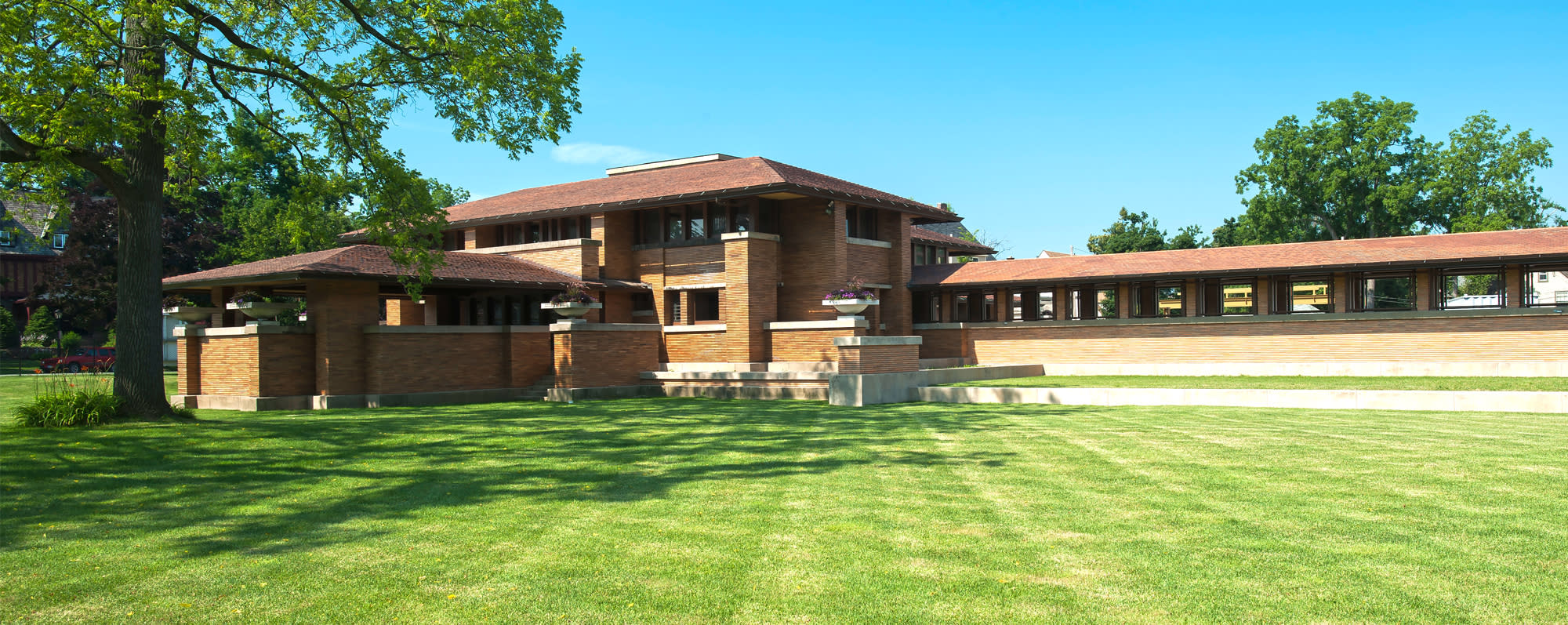 The exterior of Frank Lloyd Wright's Martin House on a sunny day