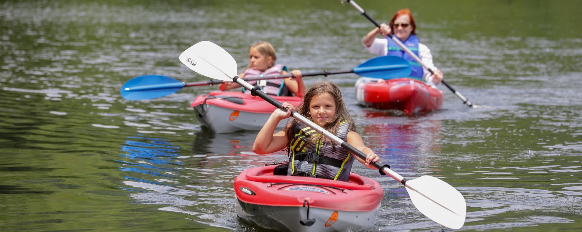 A photo of two girls and their mom kayaking at Mongaup Pond Campground