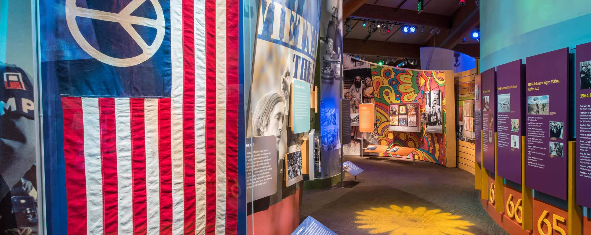 A look at the inside of the Museum at Bethel Woods displays and American flag with peace sign