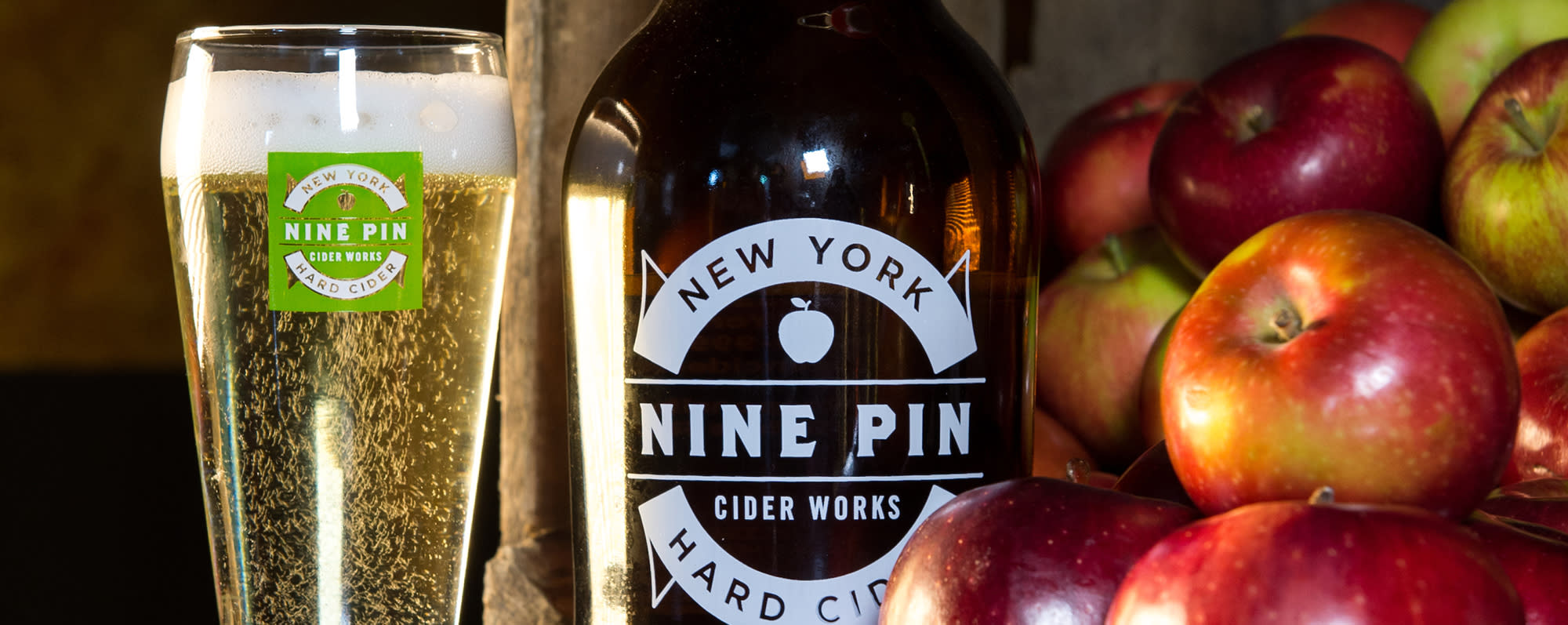 A photo of cider in a Nine Pin Cider Works glass