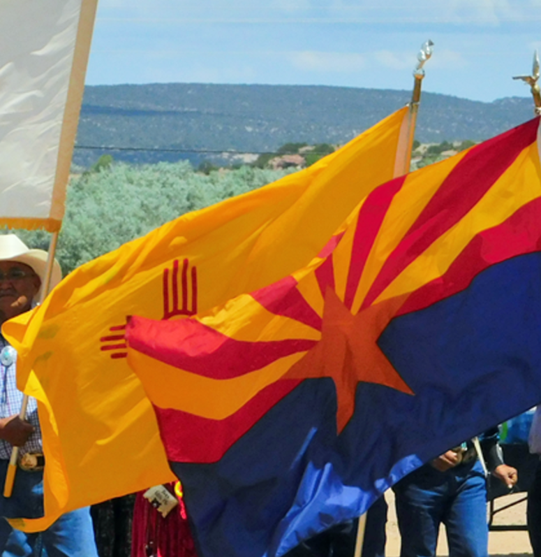 Navajo people waving Navajo Nation Flags