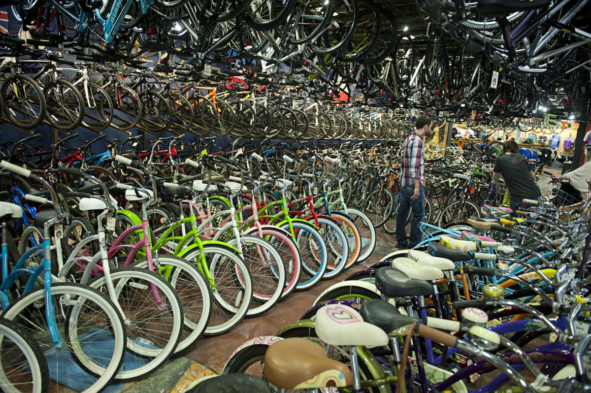 Man Walking Among Hundreds Of Bikes At University Bicycles Boulder