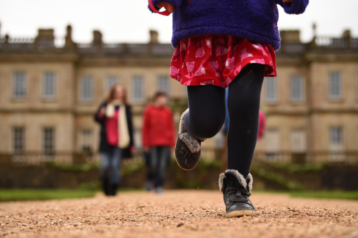 Children running in front of the house at Dyrham Park