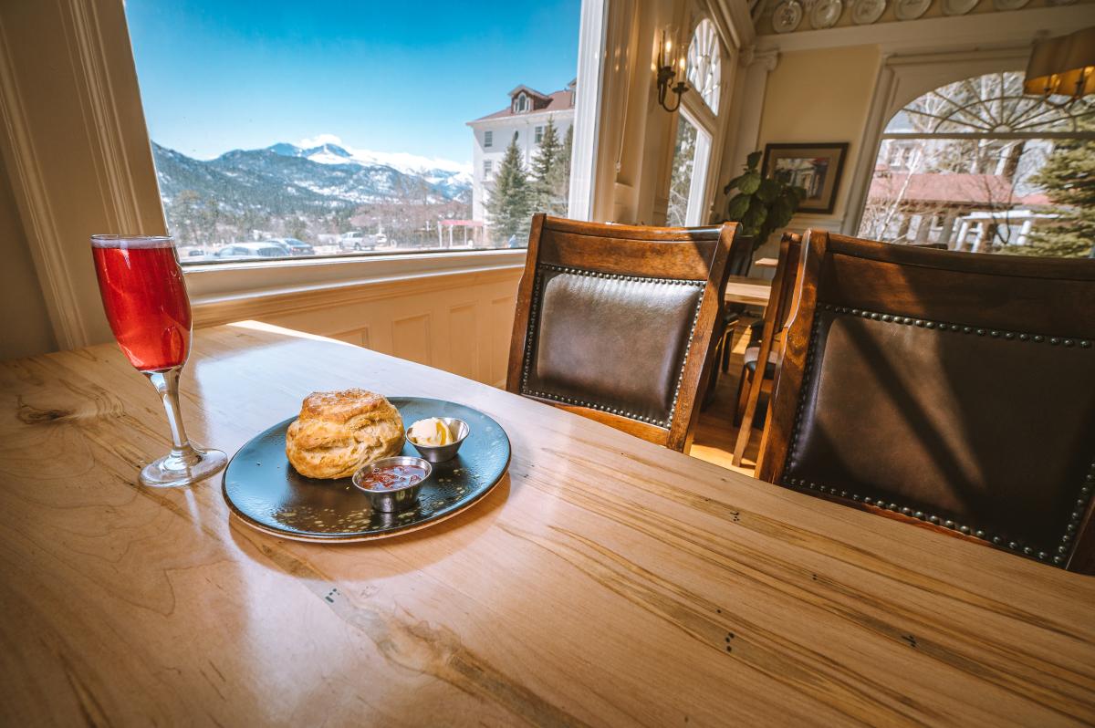 A dining table inside Brunch&Co with a view of snow covered mountains.