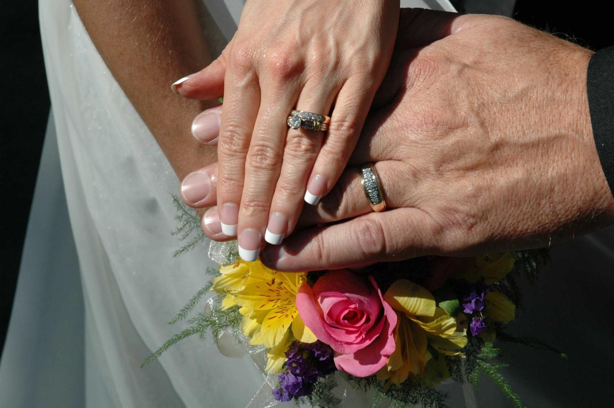 Married Couple with Rings and Flowers