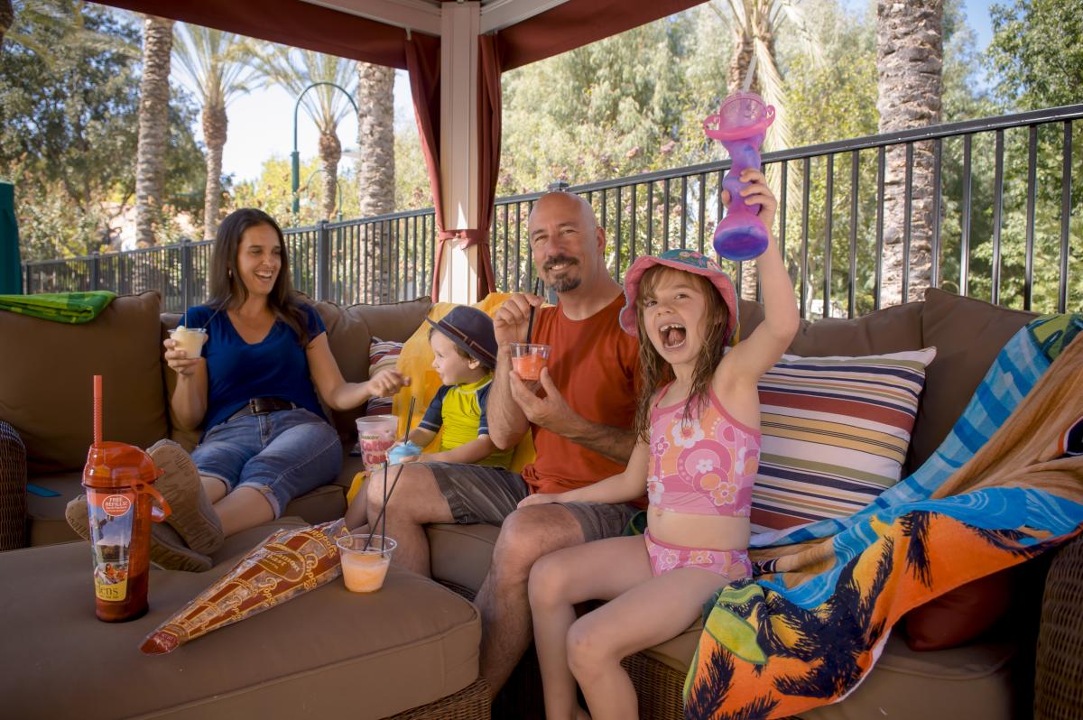 A family enjoying slushies in a cabana