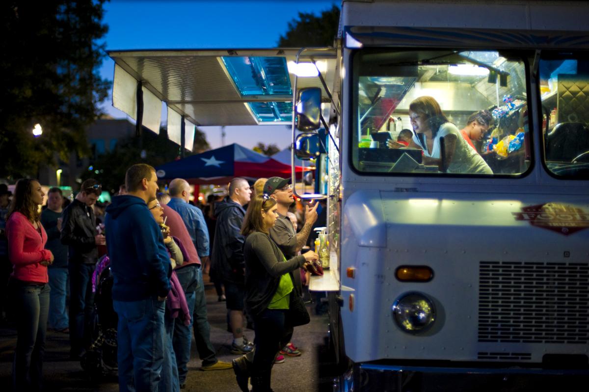Patrons order from a food truck in Huntsville, AL