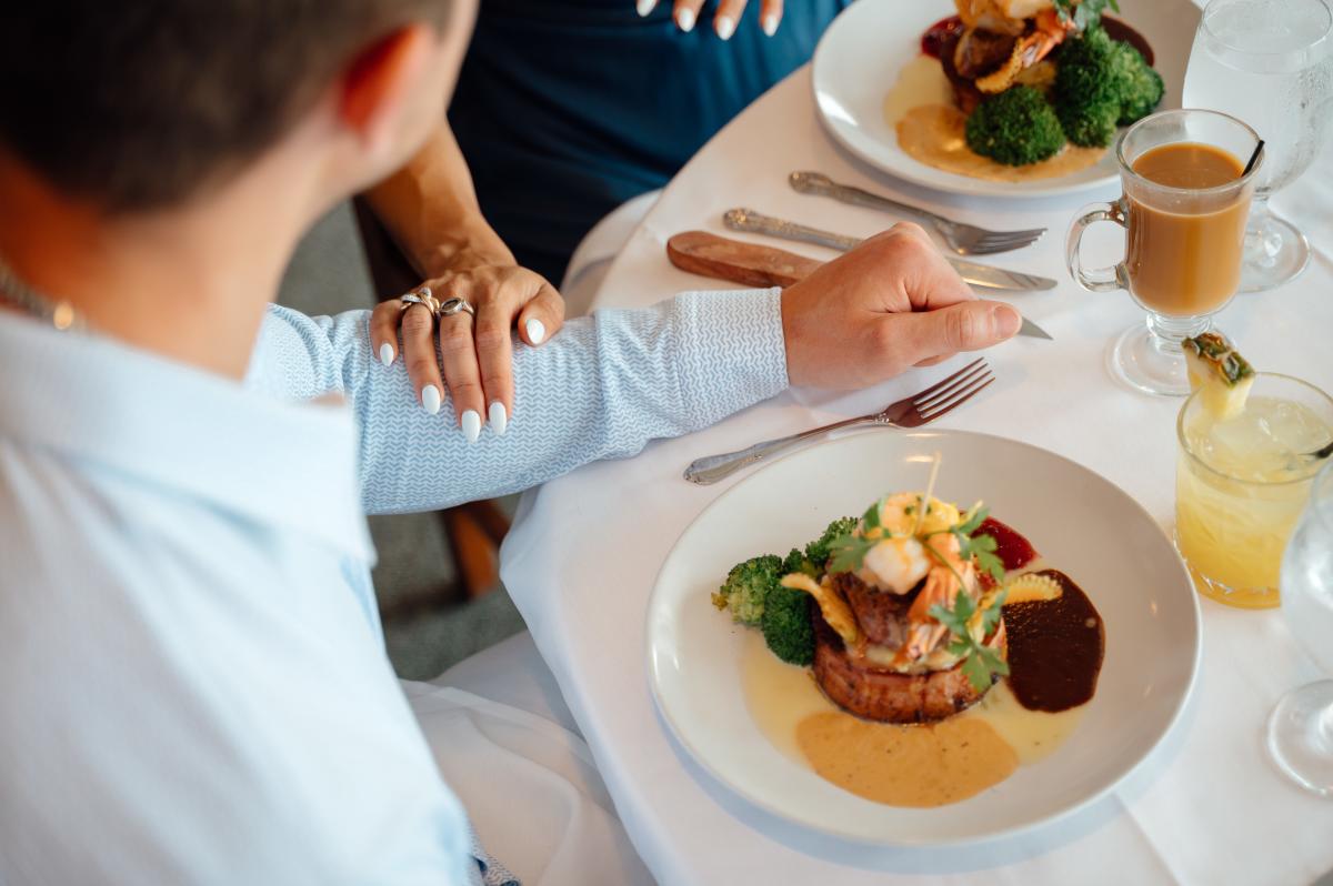 fine dining plates are set in front of a couple