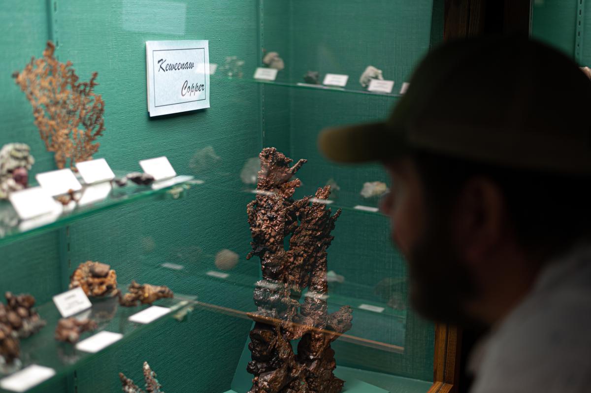 Man stares at copper specimens at AE Seaman Mineral Museum