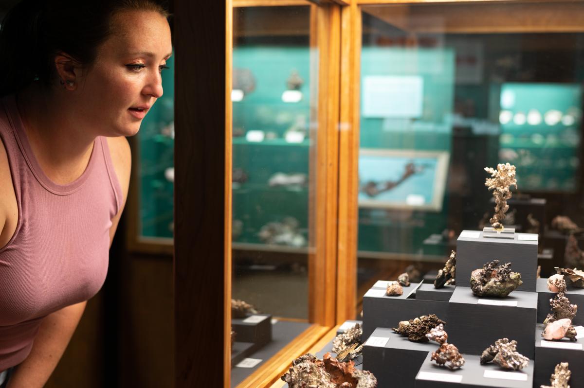 Woman looks at native copper at AE Seaman Mineral Museum