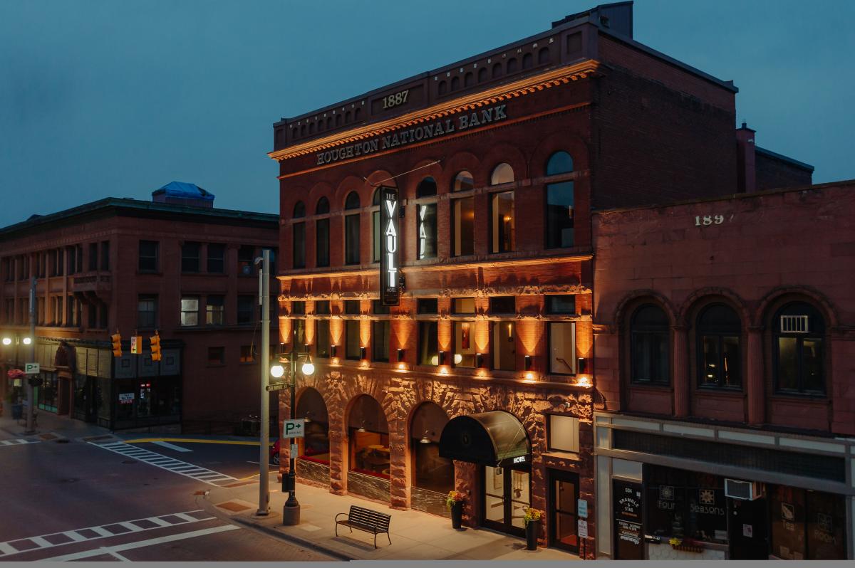 a historic building glows softly with accent lighting during evening's fall