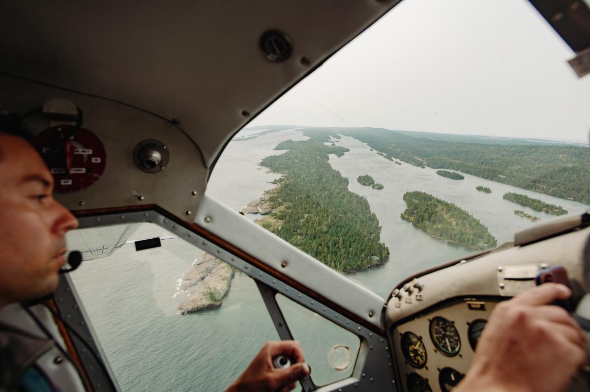 Pilot in seaplane overlooking islands
