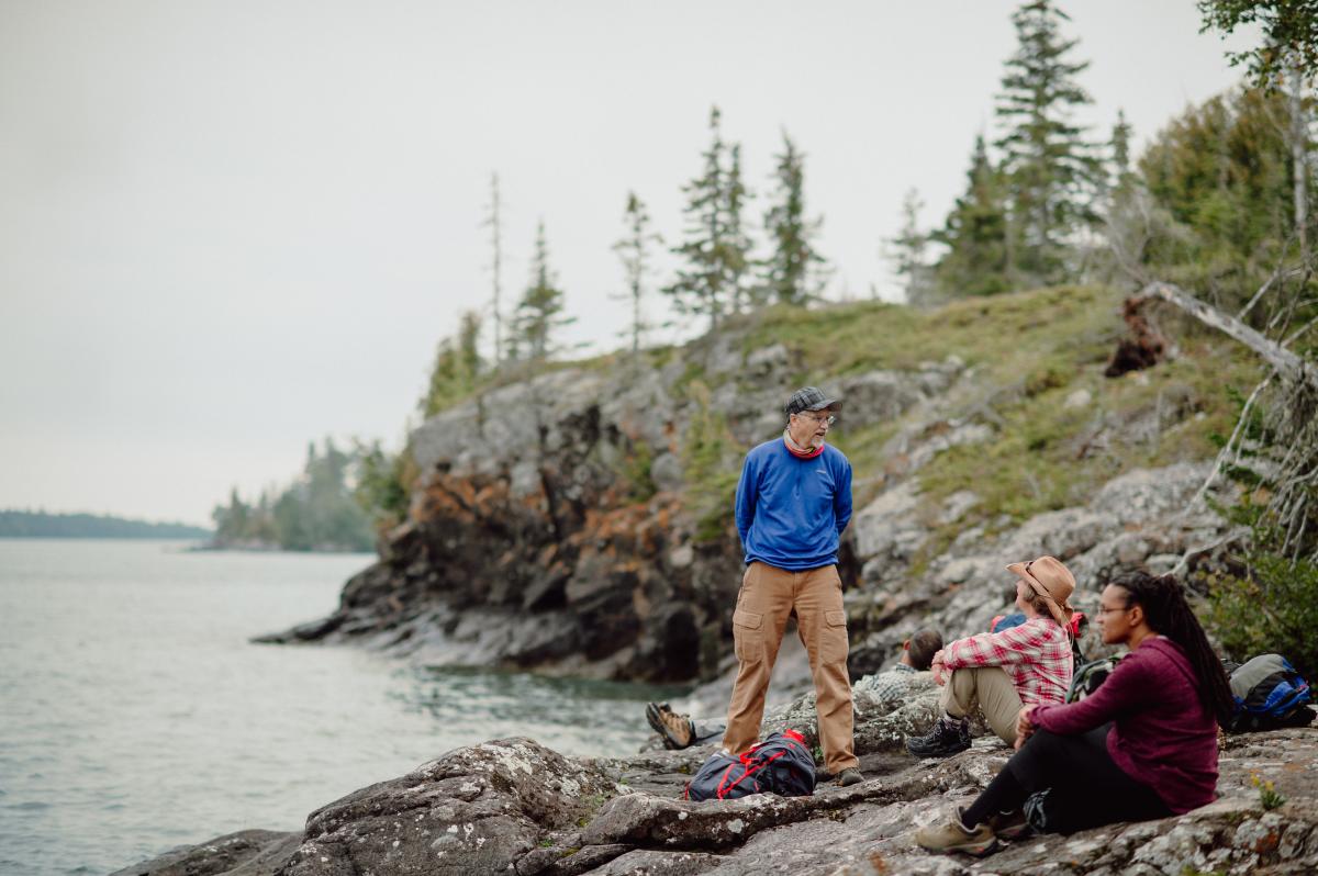 Group takes a break from hiking on the rugged shores of Isle Royale