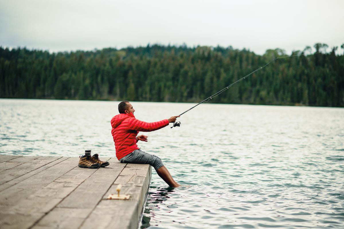 A fisherman casts a line of a dock on Isle Royale.