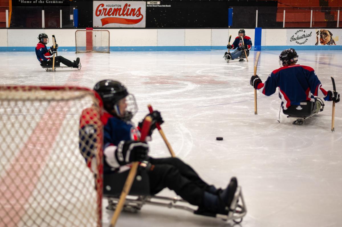 sled hockey players skate the ice