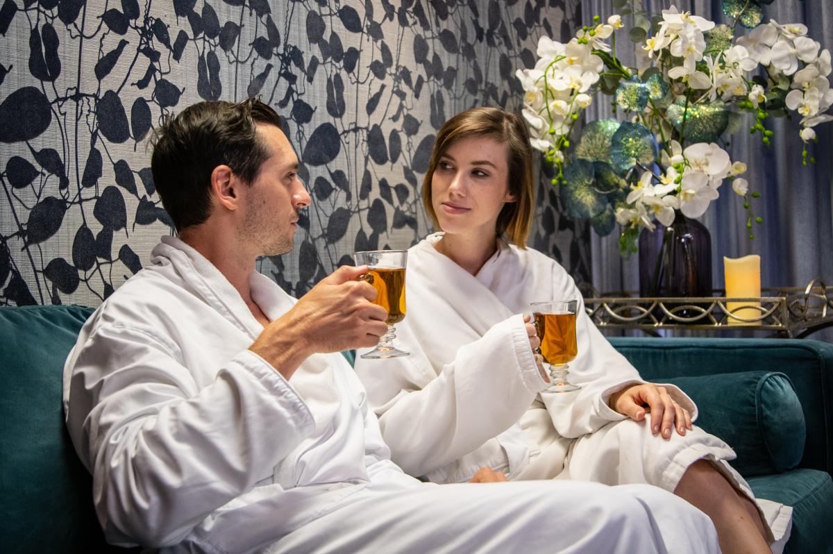 A couple relaxes in robes at the ARIA Medispa, Yoga and Wellness Center