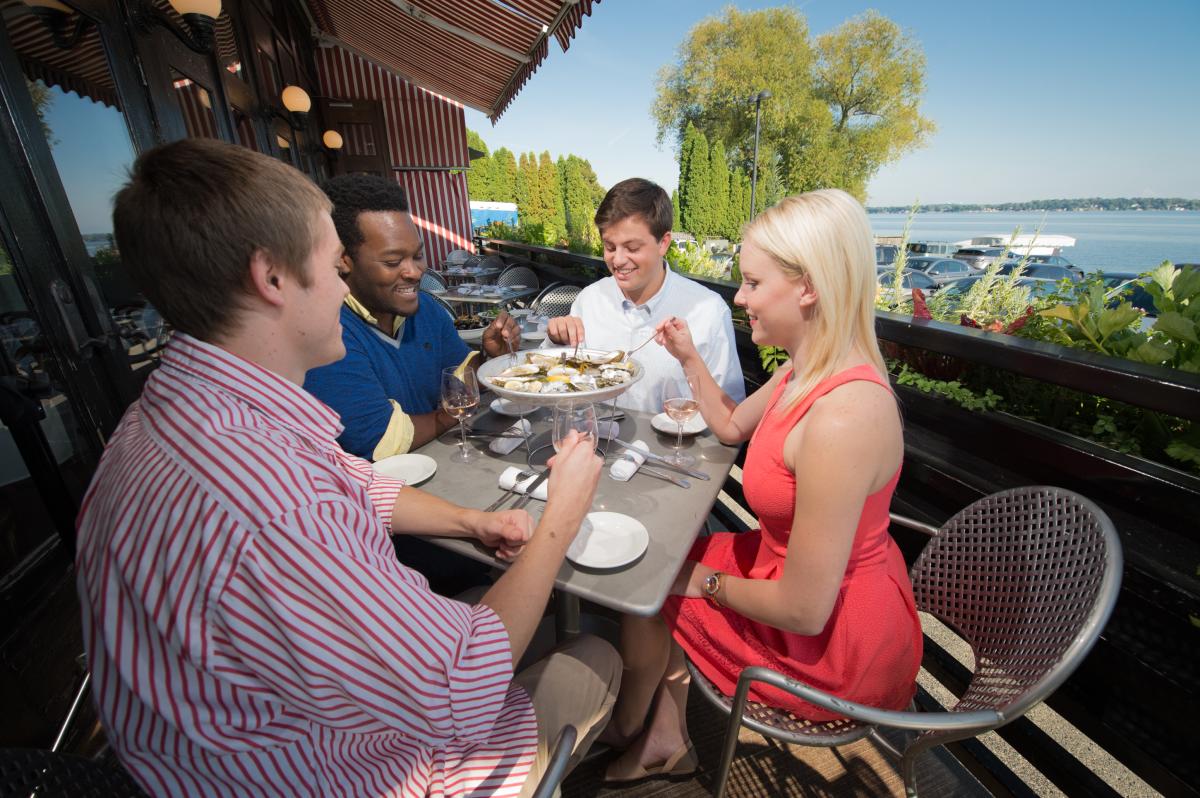 A group of friends dine on oysters at Sardine, along Lake Monona.