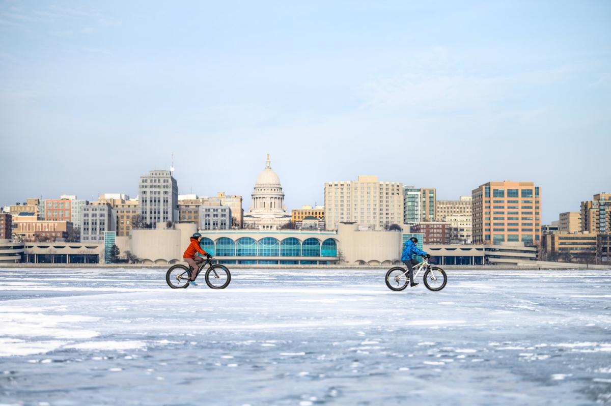 2 people bike on frozen Lake Monona