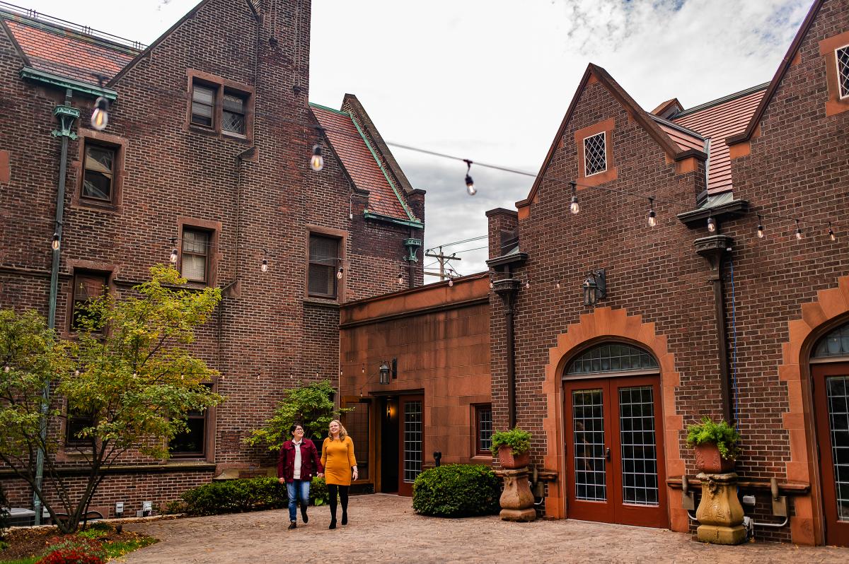 couple walking and holding hands in courtyard