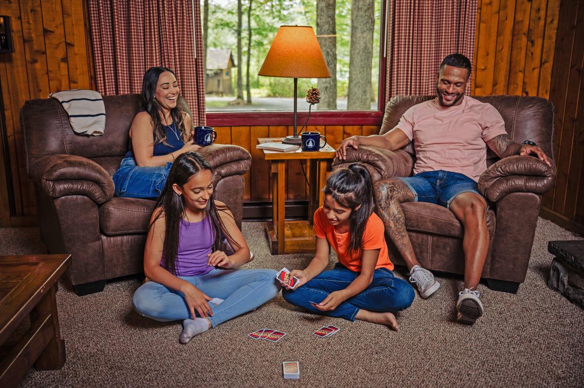 A family playing card games in their secluded cabin