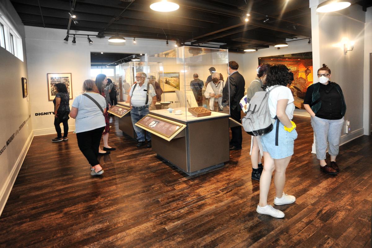 People walking around an viewing history exhibits