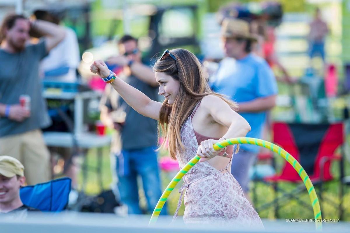 Girl with hula hoop at outdoor festival
