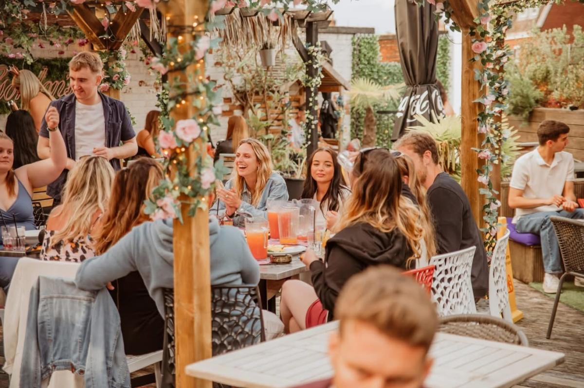 People enjoying brunch on outdoor terrace of Funky Flamingo