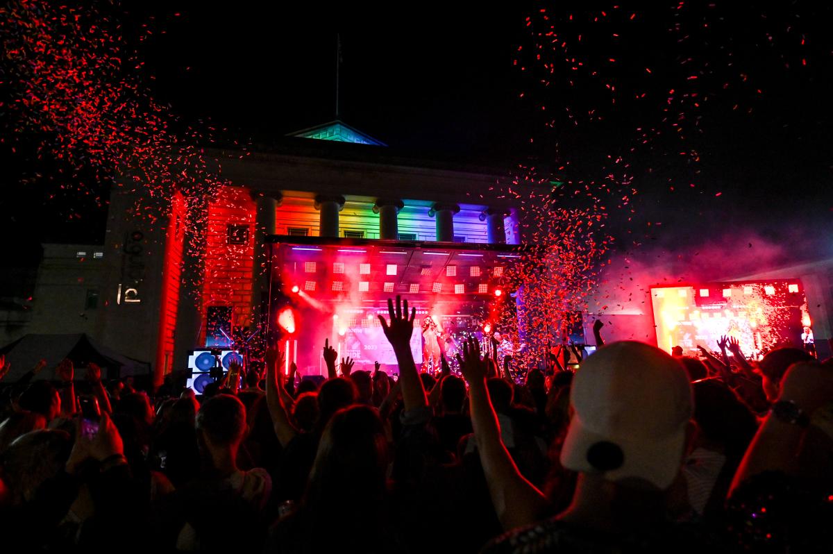 Guildhall Square filled with cheering crowd in front of stage for Southampton Pride performance at night.