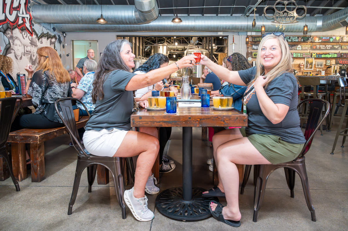 Meeting planners toast each other while drinking beer at Nortons Brewing Co.