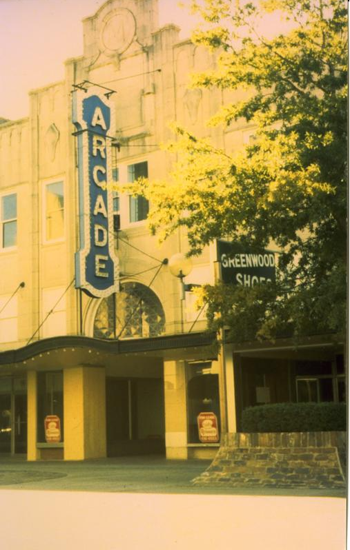 color photo of arcade theater with a large arcade sign in front above the awning
