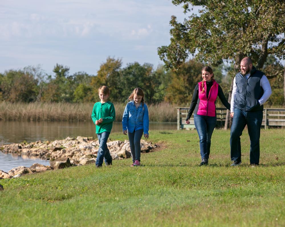Family Walking Along Lake Bastrop In Bastrop, TX