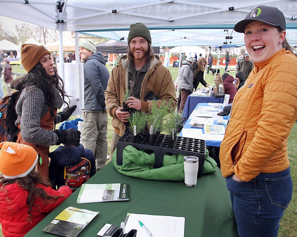 A family visits a booth at the Earth Day Celebration in Fort Collins