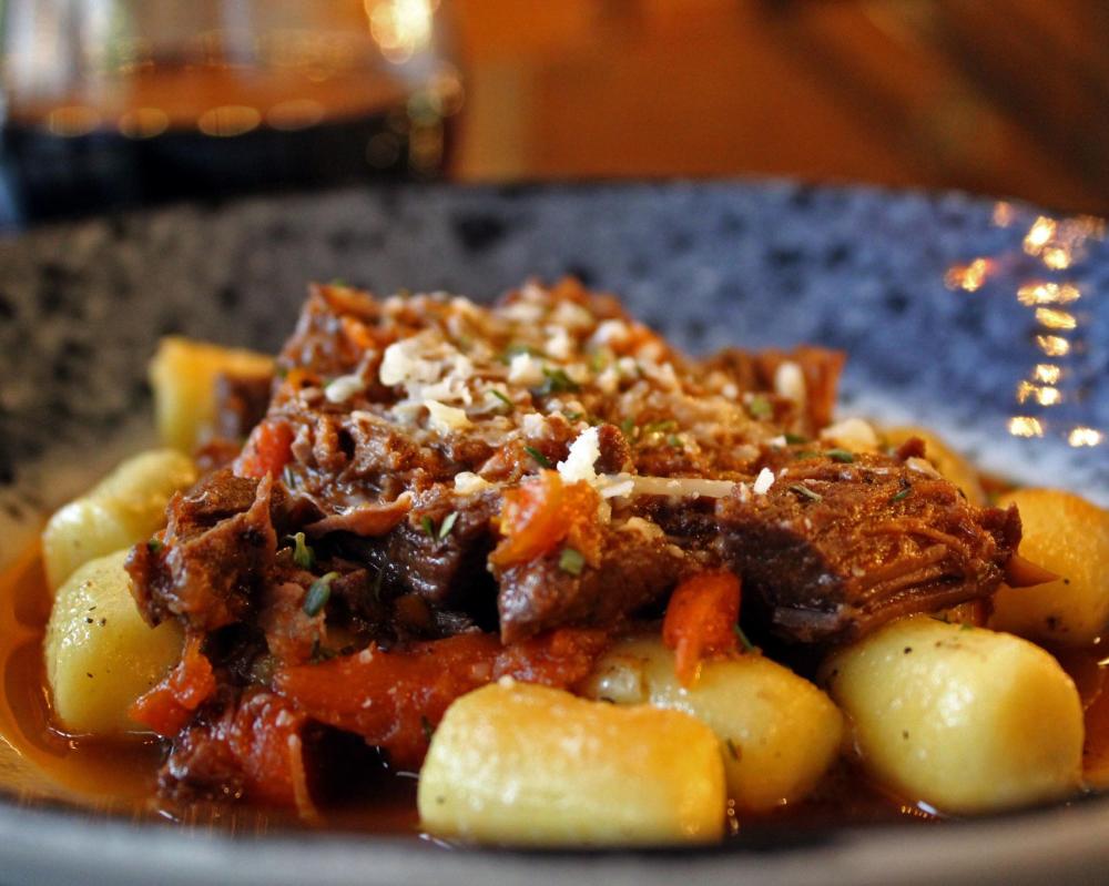 Gnocchi and braised lamb on plate