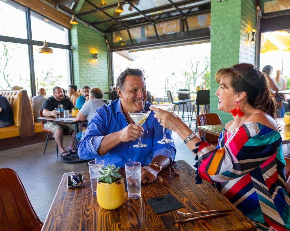 Couple toasting at 1501 Gastropub.