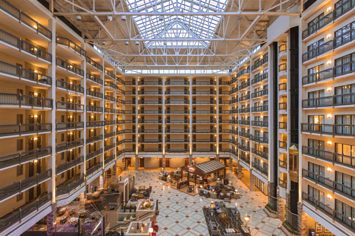 Image of the interior of the hotel that shows the first level with restaurants and the each floor of rooms rising above.