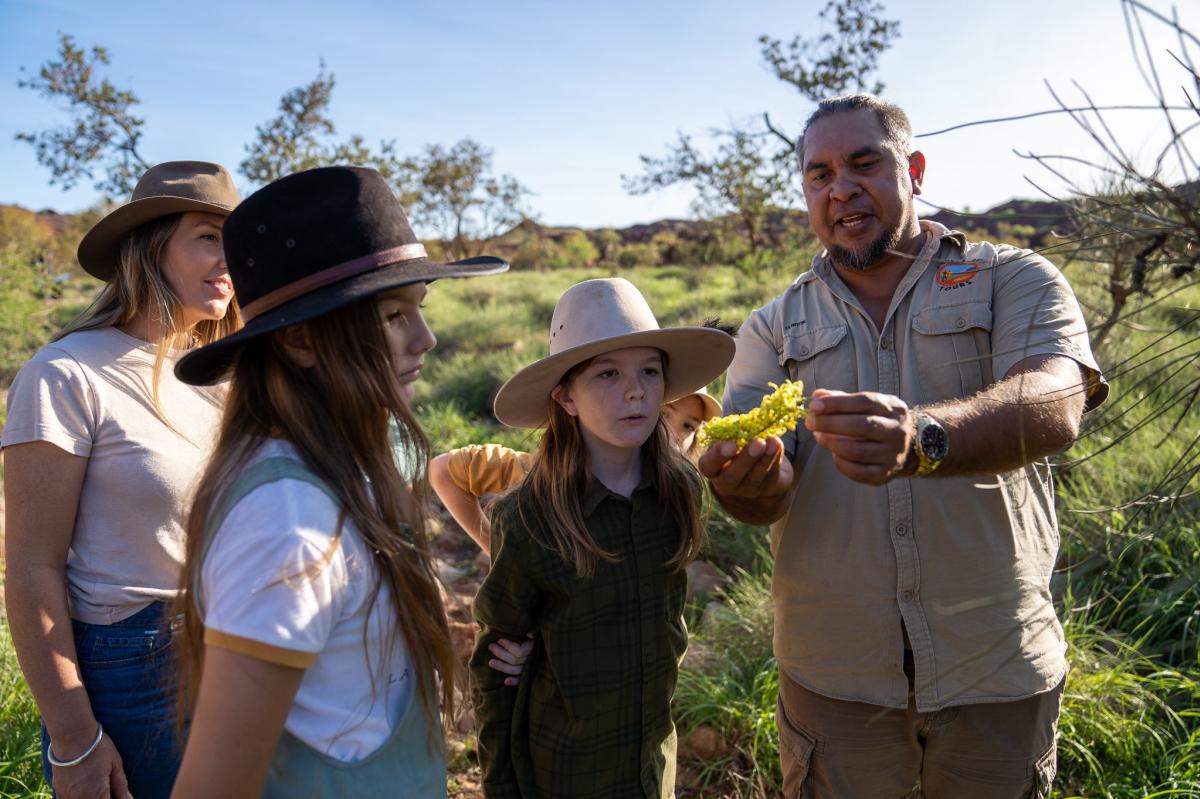 Owner-operator Clinton Walker shows native plants to a tour group