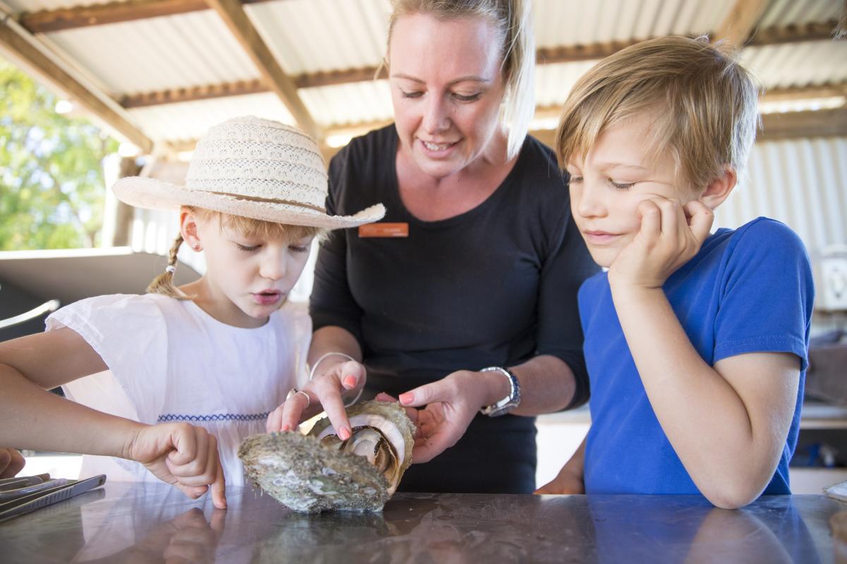 Children learning about pearls at the Willie Creek Pearl Farm Tour