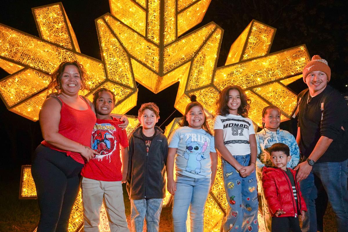 Family photo at the riverwalk during lost pines christmas