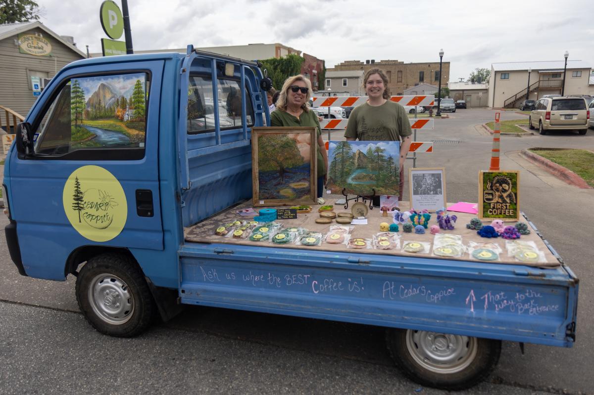 The Cedar's Coppice team at the F.A.M.E. Days event with a blue truck selling baked goods and craft items.
