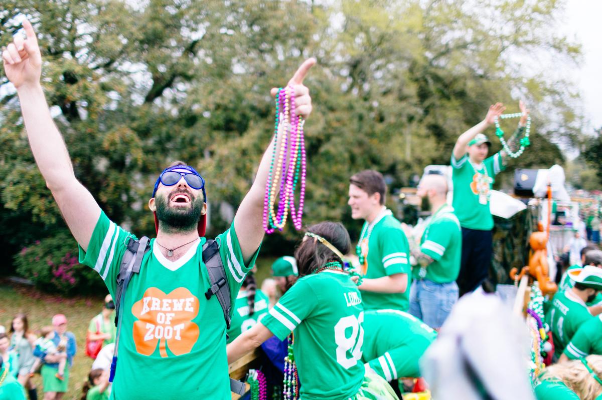 Man throwing beads at the annual Wearin' of the Green parade