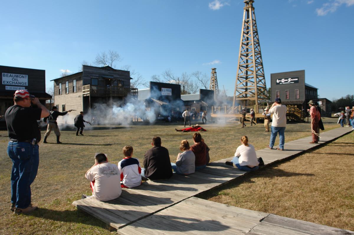 Spindletop history as actors portray a shootout at the anniversary celebration.