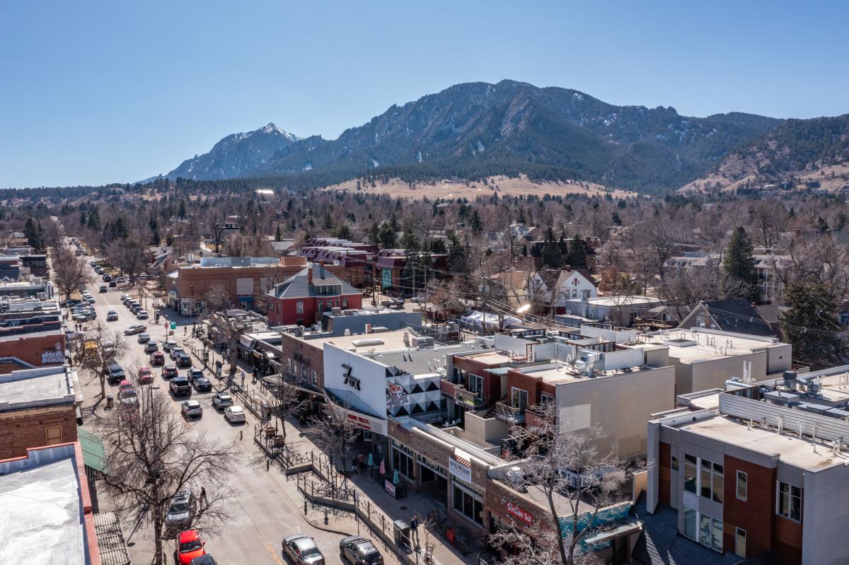 Aerial photo of The Hill neighborhood with The Flatirons in the background in Boulder, CO