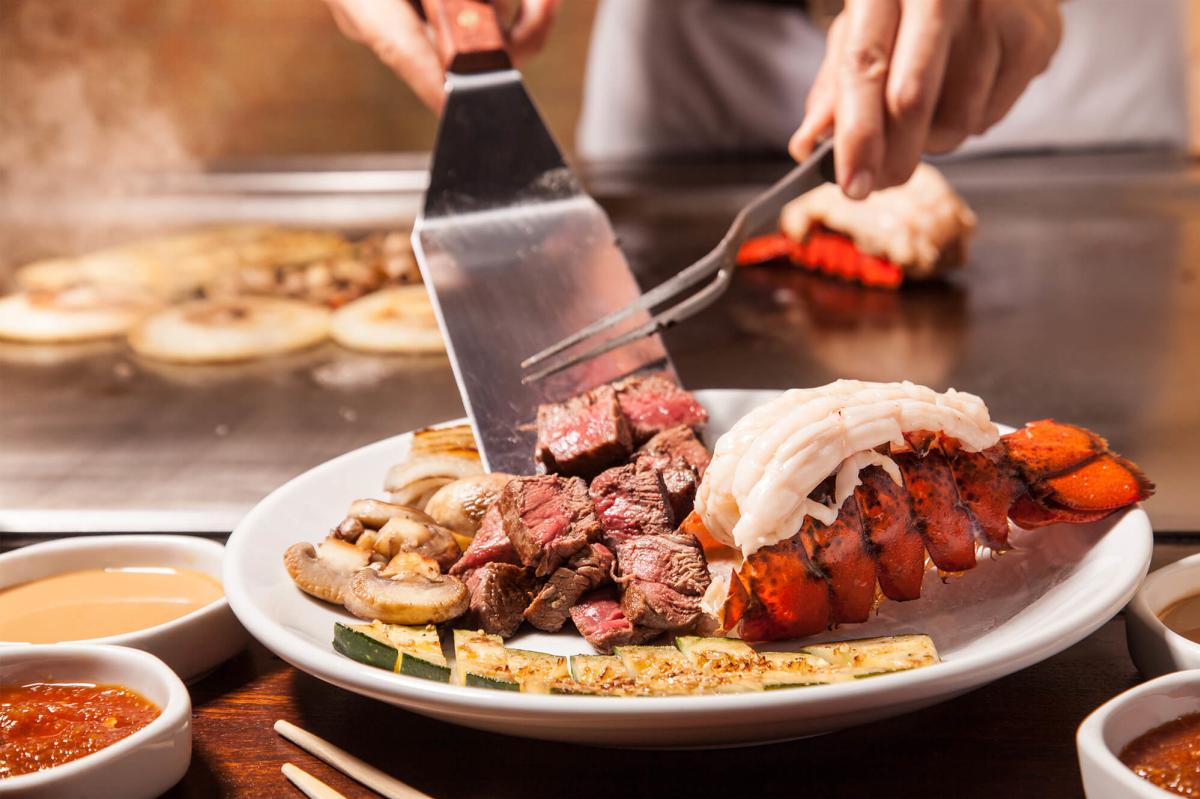 Hibachi style steak and lobster being served.