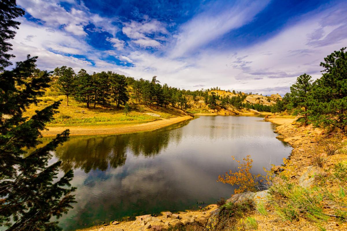 Angler casting a line at Crystal Reservoir, a hidden gem for fishing near Cheyenne.